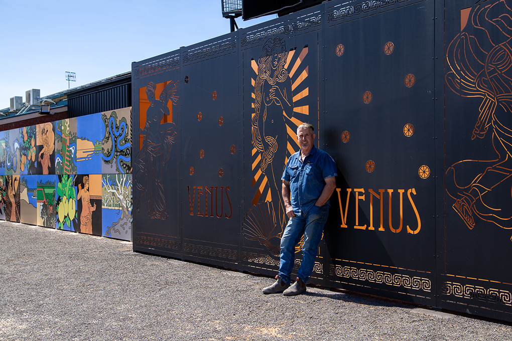 Garry Duncan standing in front of his mural at Venus Citrus  in Loxton